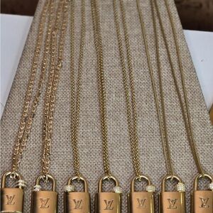 Necklaces repurposed with authentic LV locks.